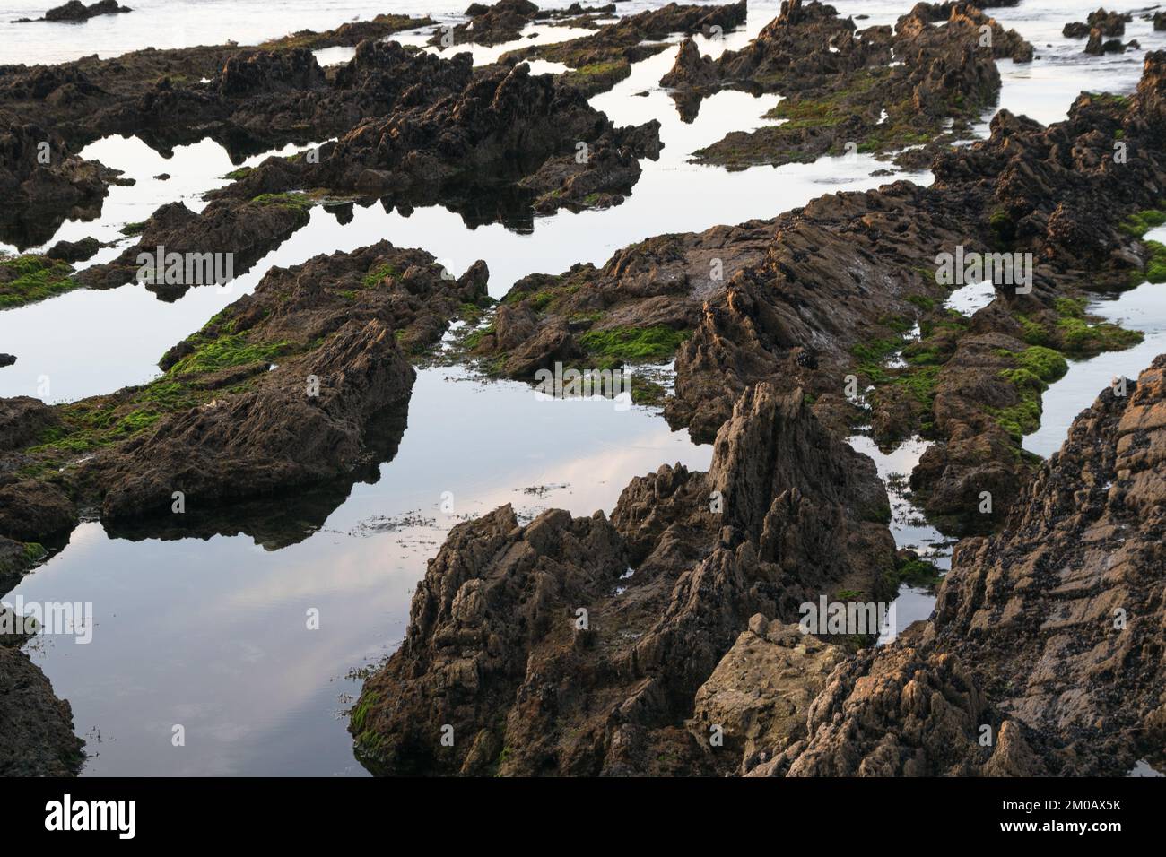 Water between a rock formation on the seashore Stock Photo - Alamy