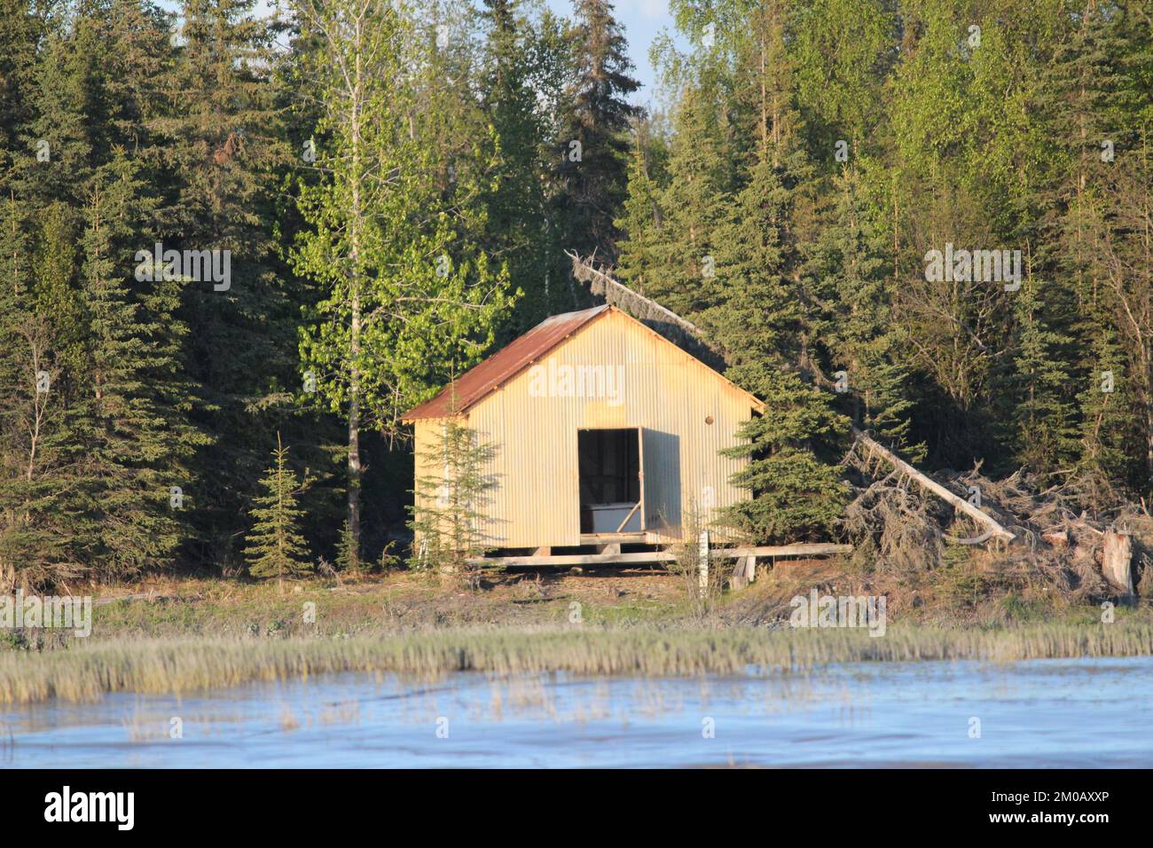 Abandoned trappers cabin on a rocky shoreline Stock Photo Alamy