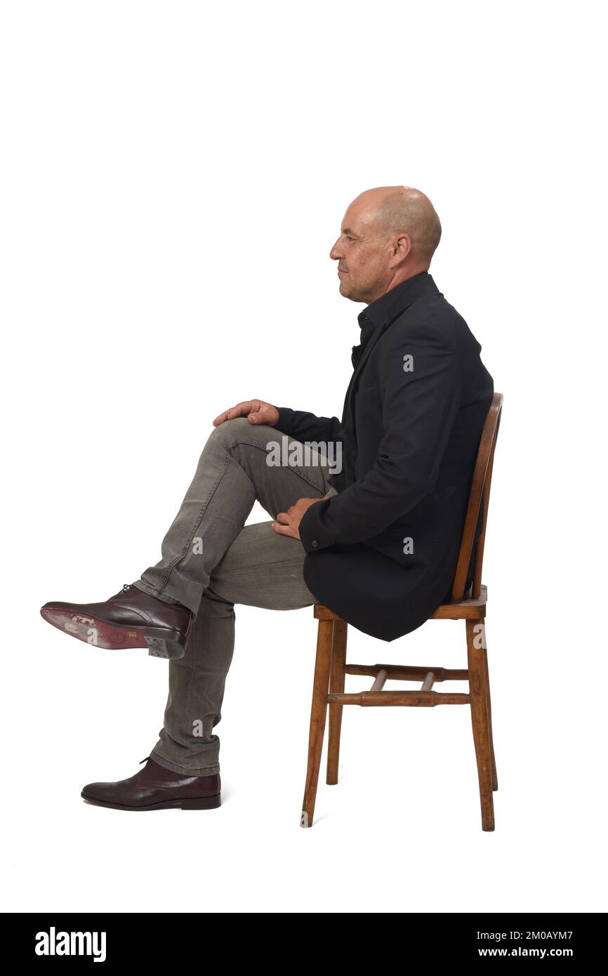 side view of a man sitting on chair with crosslegged on white background Stock Photo Alamy
