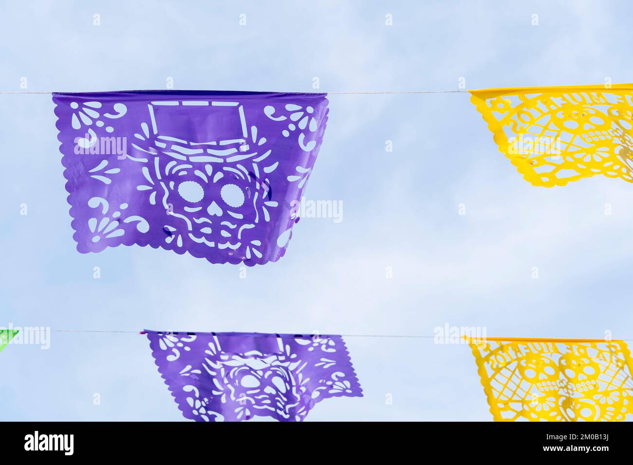 decoration day of the dead, purple and yellow papel picado, sky background, mexico Stock Photo
