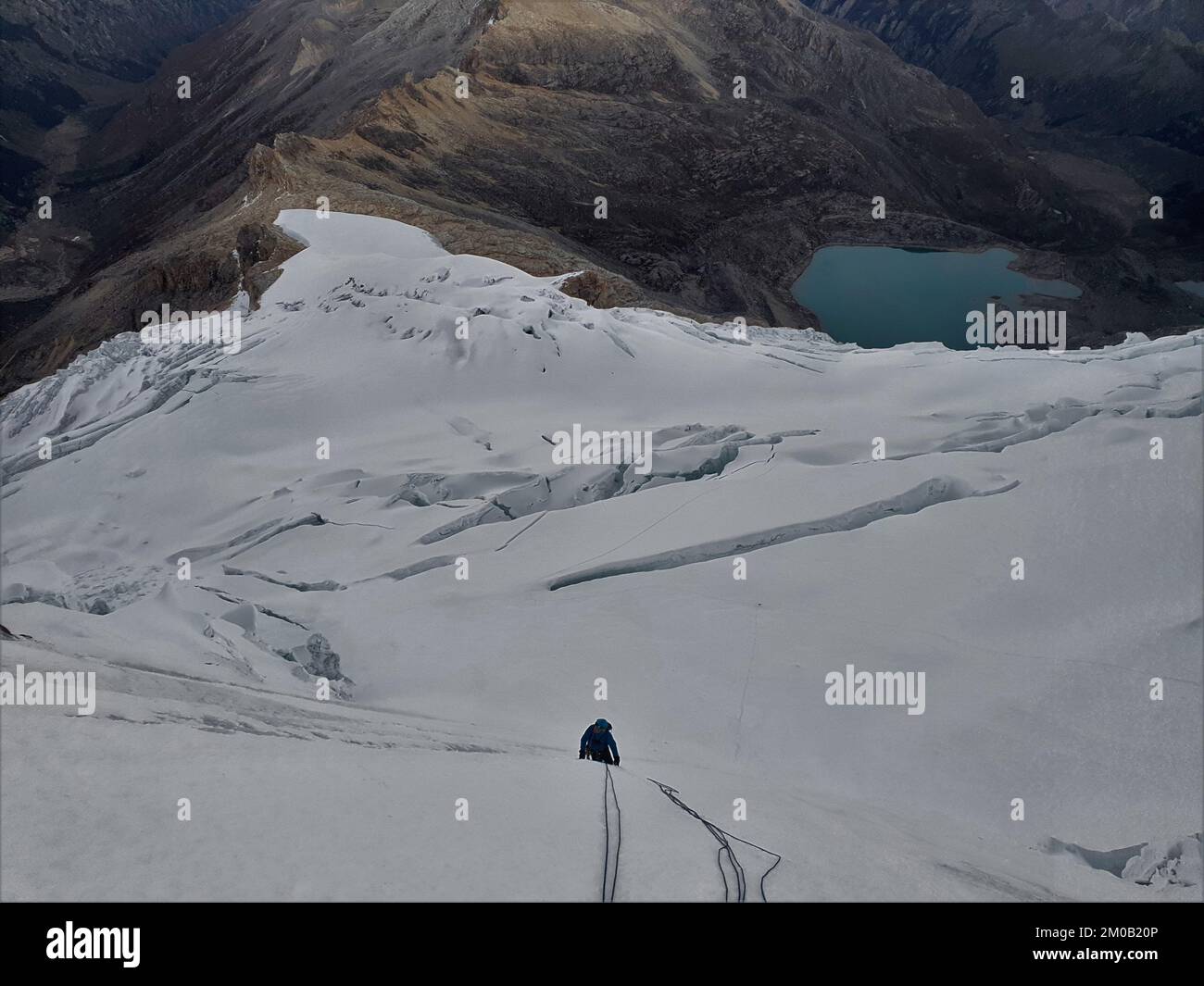 An alpinist climbing the snowy Yanapaccha mountain of the Cordillera