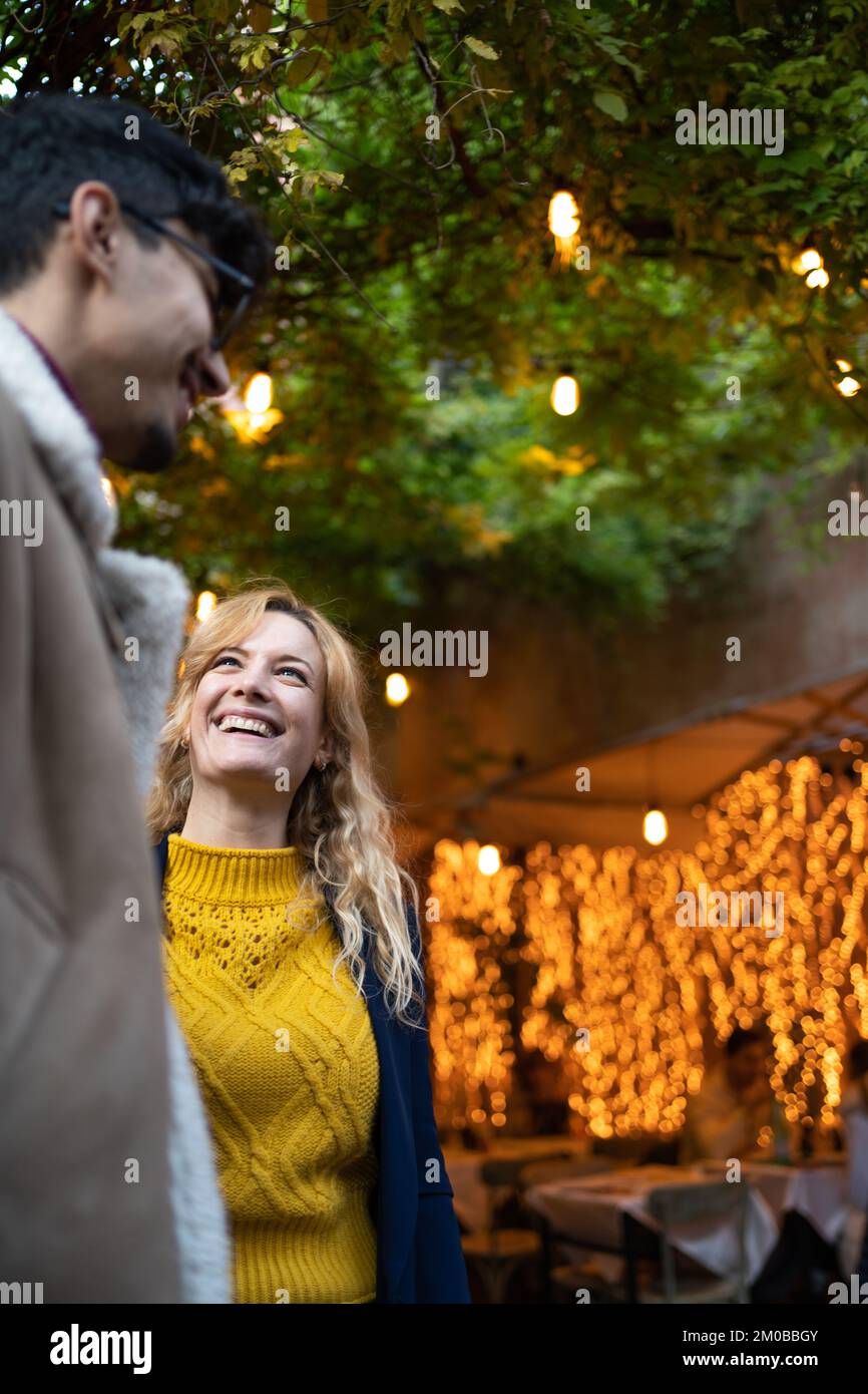 selective focus on happy blonde woman talking with a friend Stock Photo