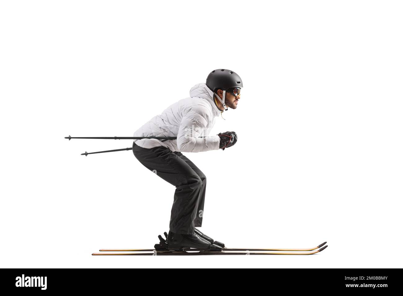 Full length profile shot of a male skier skiing isolated on white background Stock Photo