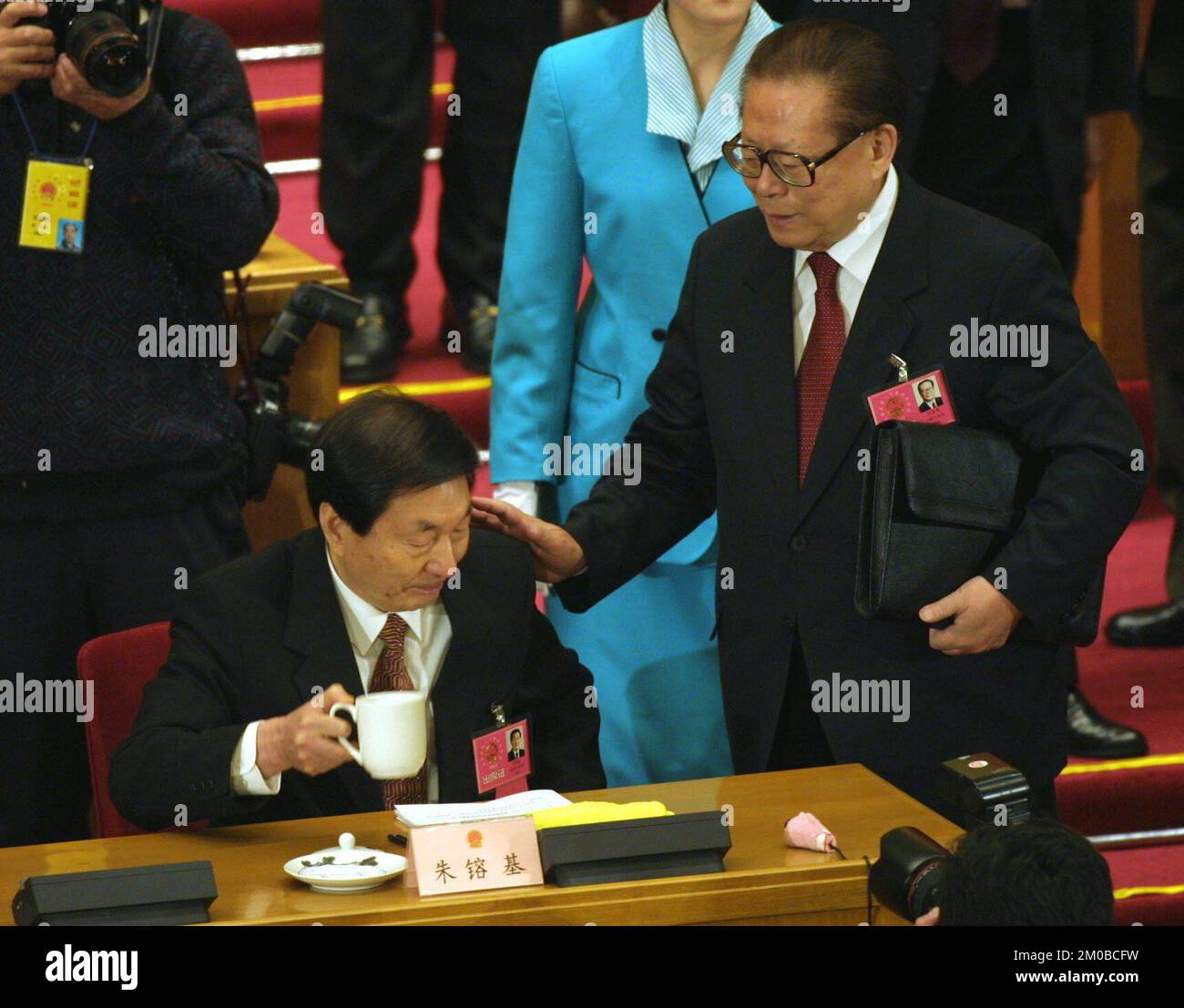President Jiang Zemin pats Premier Zhu Rongji on his shoulder and congraduates him on his
