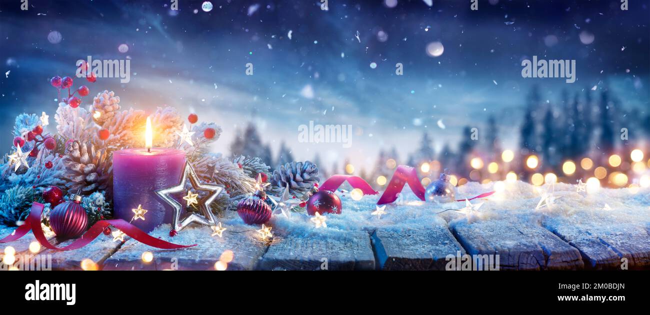 Advent Candle With Christmas Decoration On Snow Table And Abstract ...