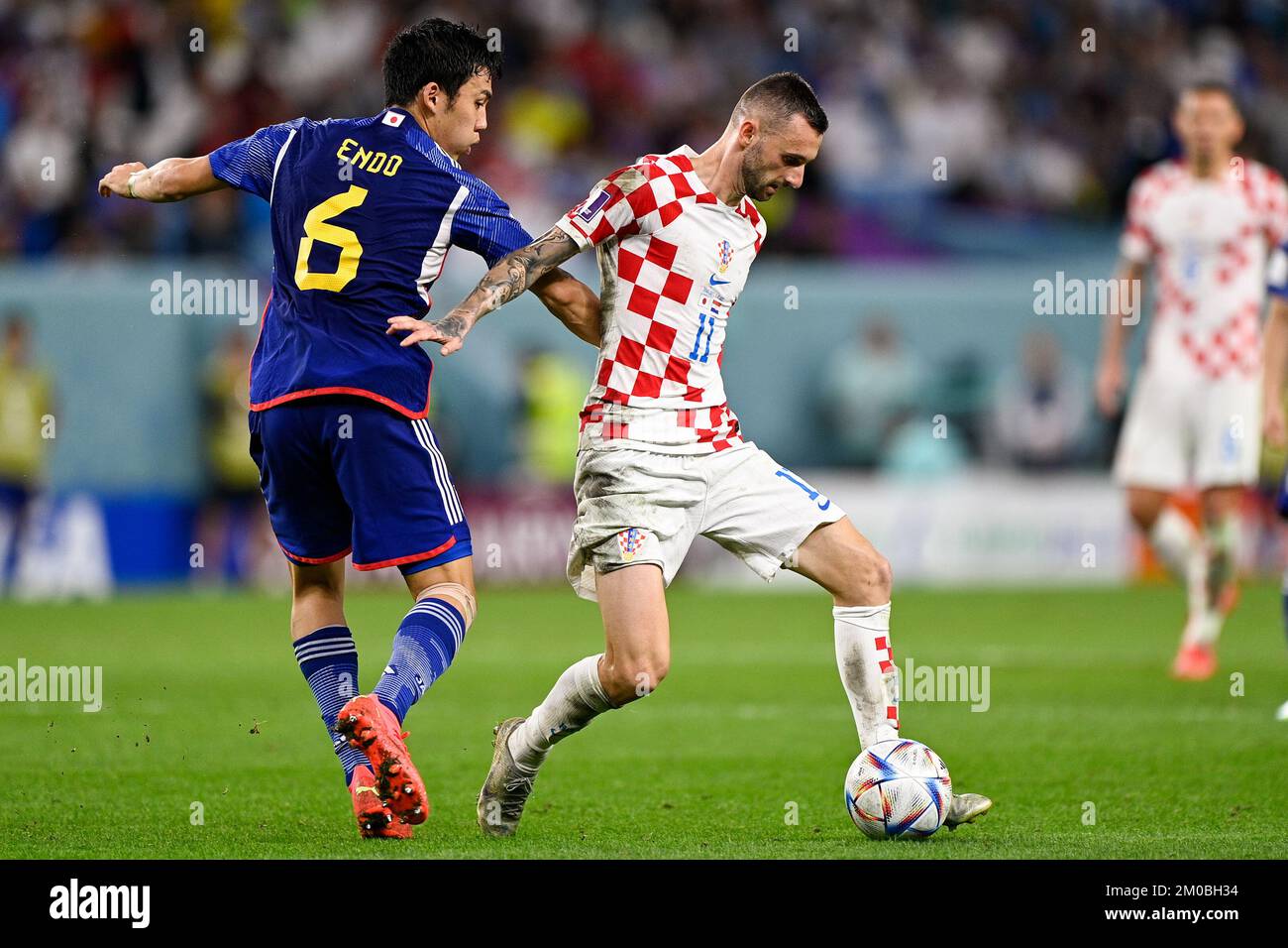 AL WAKRAH, QATAR - DECEMBER 5: Wataru Endo of Japan battles for the ball with Marcelo Brozovic of Croatia during the Round of 16 - FIFA World Cup Qatar 2022 match between Japan and Croatia at the Al Janoub Stadium on December 5, 2022 in Al Wakrah, Qatar (Photo by Pablo Morano/BSR Agency) Stock Photo