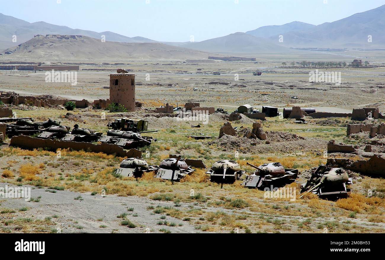 Destroyed tanks and armored vehicles abandoned in a field near Ghazni in Afghanistan. Stock Photo