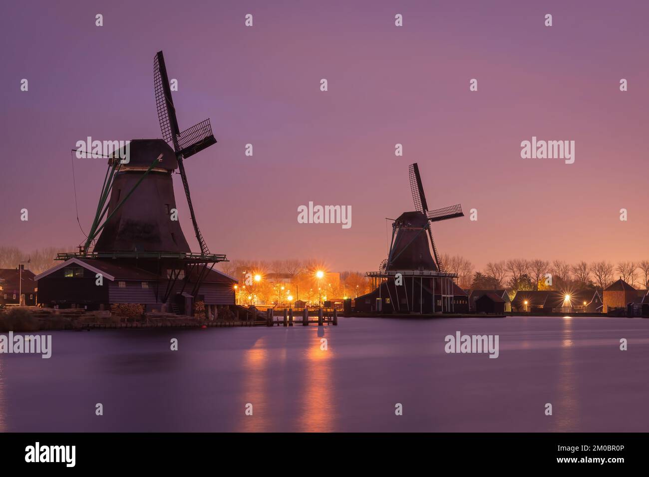 Traditional dutch windmills at Zaanse Schans by sunset Stock Photo