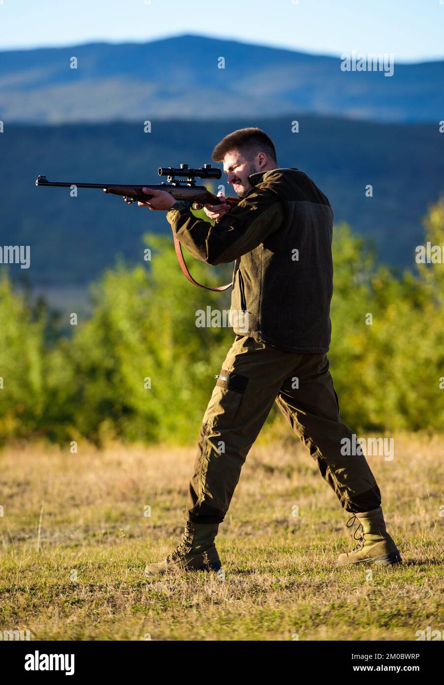 Man rifle for hunt. Hunter khaki clothes ready to hunt hold gun mountains  background. Hunter with rifle looking for animal. Hunting shooting trophy  Stock Photo - Alamy