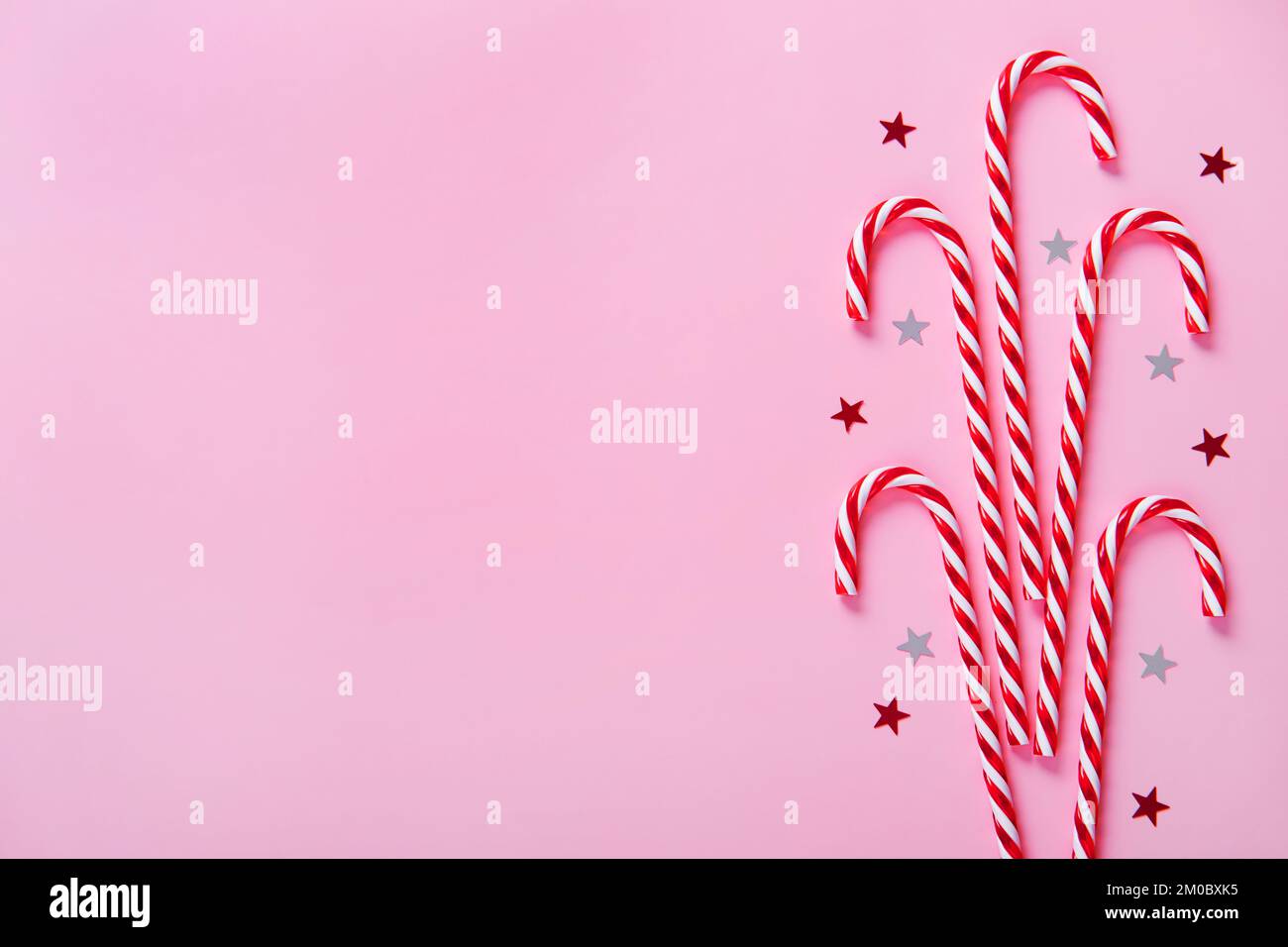 Christmas composition. Candy canes, holiday decorations on a pink ...