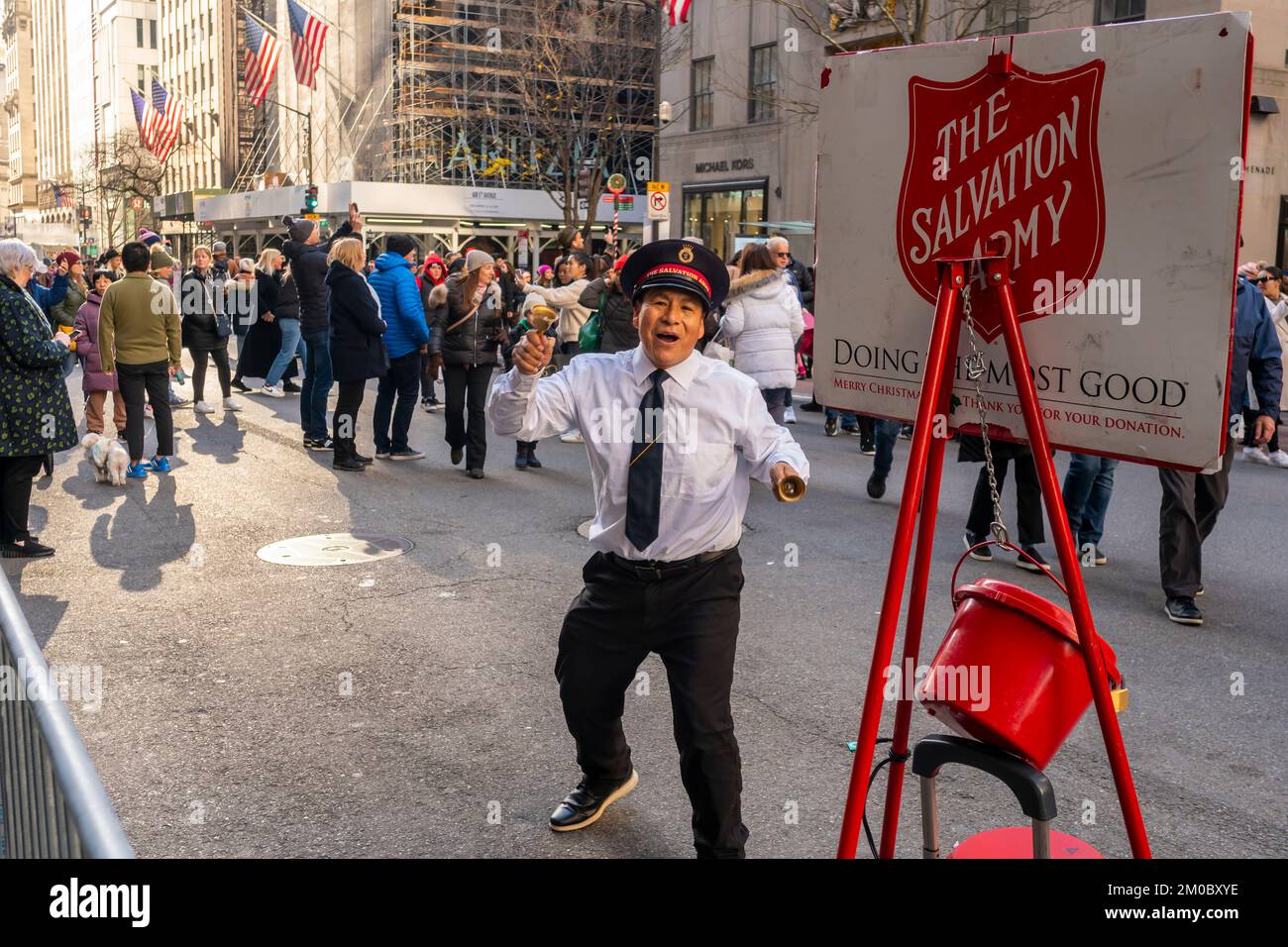 Energetic Salvation Army Kettle workers on a carfree Fifth Avenue in Midtown Manhattan to enjoy