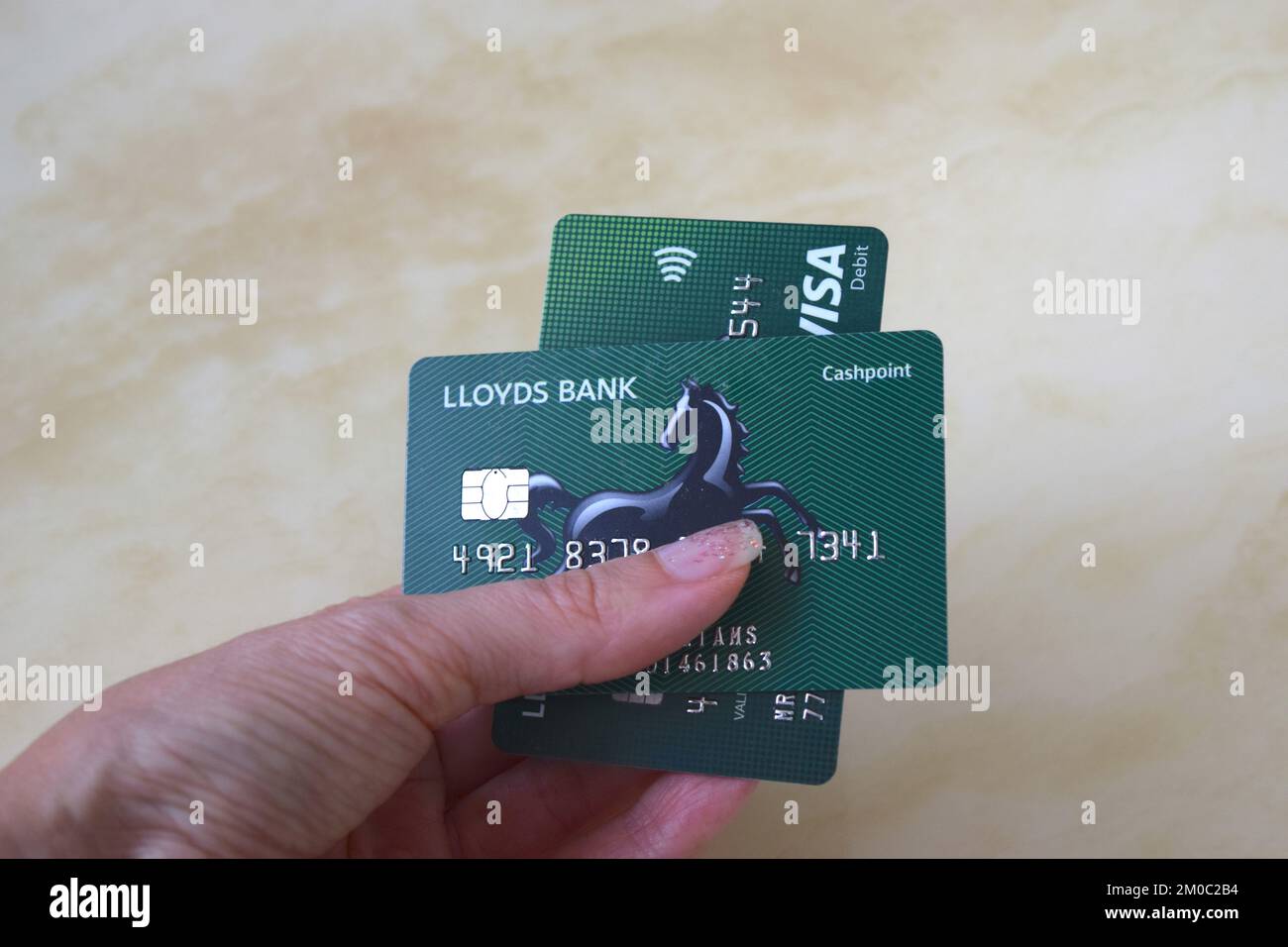 Lloyds bank card in hand on light background. Stock Photo