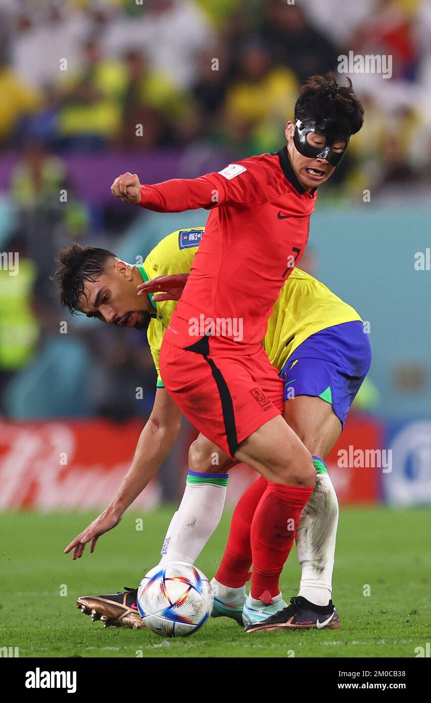 Doha, Qatar, 5th December 2022.  Heungmin Son of Korea  tackled by Lucas Paqueta of Brazil  during the FIFA World Cup 2022 match at Stadium 974, Doha. Picture credit should read: David Klein / Sportimage Stock Photo