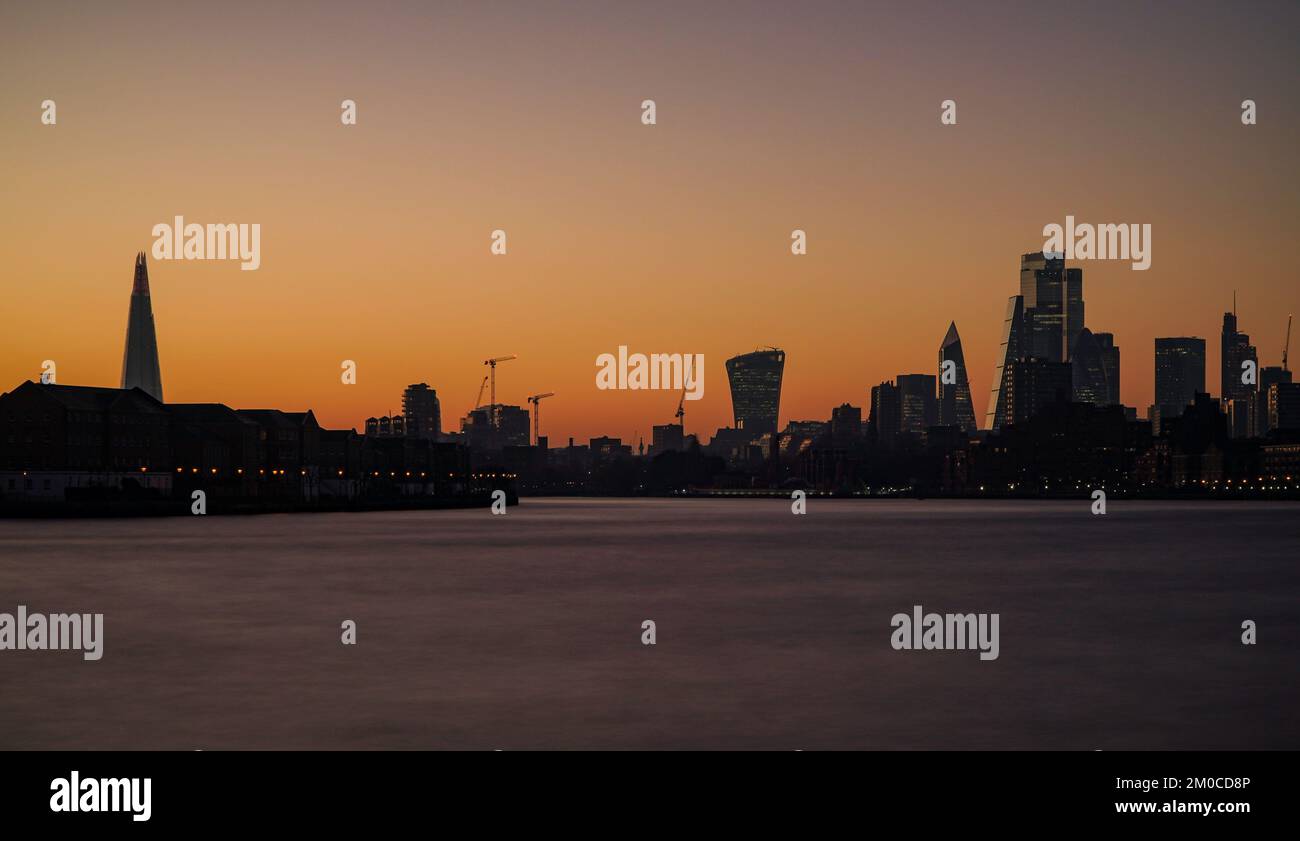 A beautiful sunset over London with modern high-rise buildings against a golden sky Stock Photo