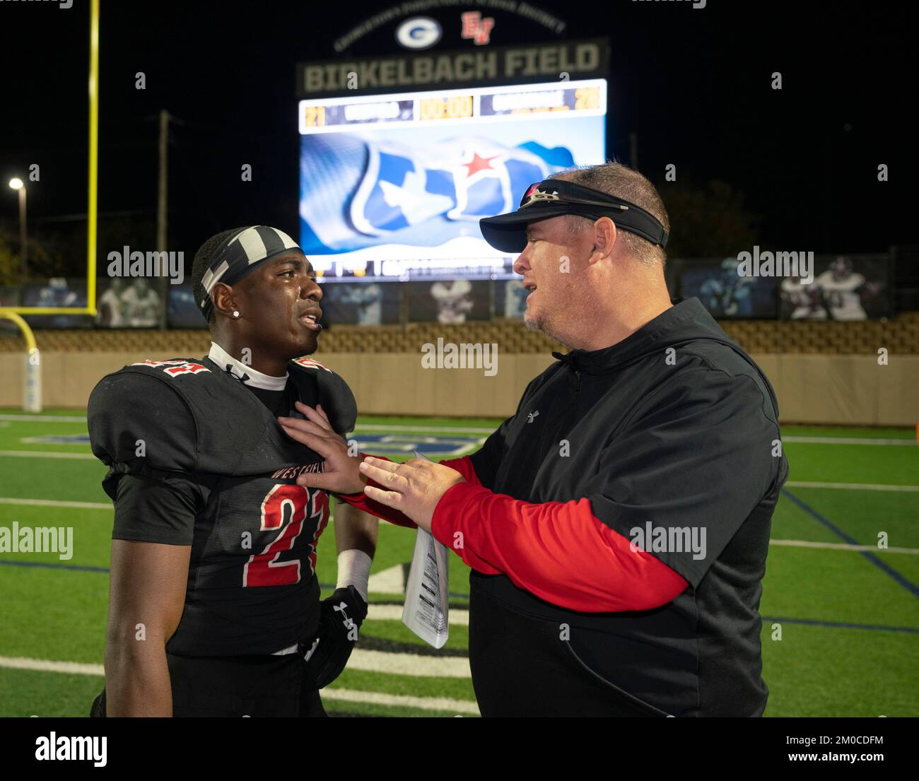 Georgetown Texas USA, December 3 2022: Coach comforts disappointed player after their team's loss in a University Scholastic League (UIL) quarter-final playoff football game in central Texas. ©Bob Daemmrich Stock Photo