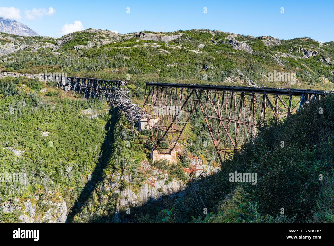 Old abandoned and collapsed railroad bridge along White Pass in Alaska near Skagway Stock Photo