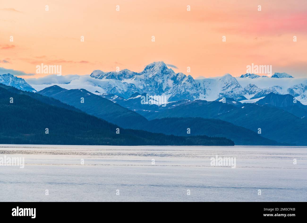 Sunset among the snow covered mountains of the Alaska Range near Whittier Stock Photo