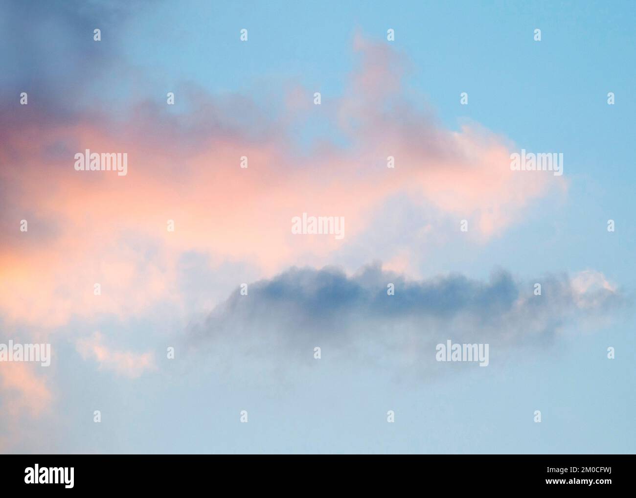 Semi abstract impressionistic colour photograph of  cloudscapes backlit by summer sun setting at woodland hideaway in the Penbryn area Stock Photo