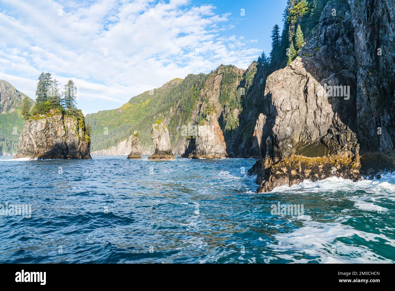 Mountains and sea stacks along the rugged coastline of Resurrection Bay near Seward, Alaska Stock Photo