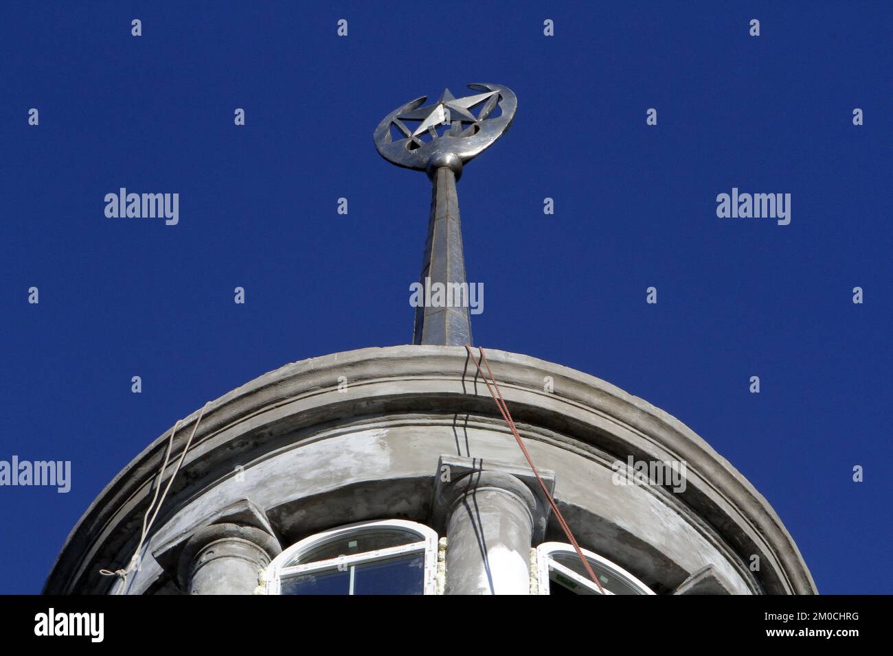 DNIPRO, UKRAINE - DECEMBER 5, 2022 - The five-pointed star, one of the Soviet symbols, that crowns the spire on the roof of a building is to be replac Stock Photo