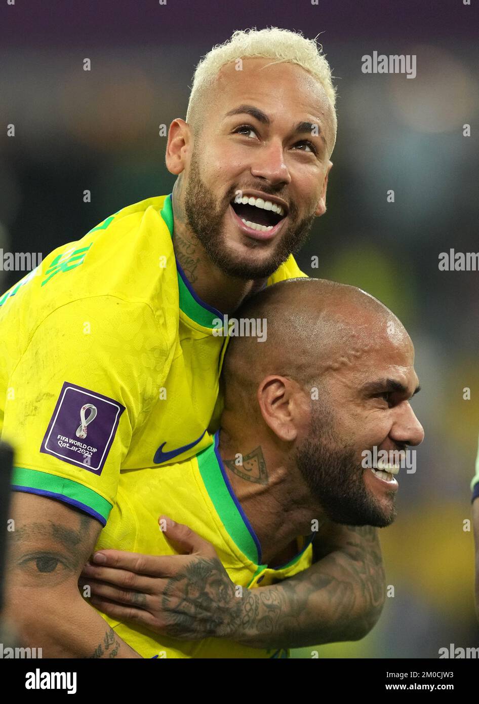 Brazil's Neymar and Dani Alves celebrate following during the FIFA World Cup Round of Sixteen match at Stadium 974 in Doha, Qatar. Picture date: Monday December 5, 2022. Stock Photo
