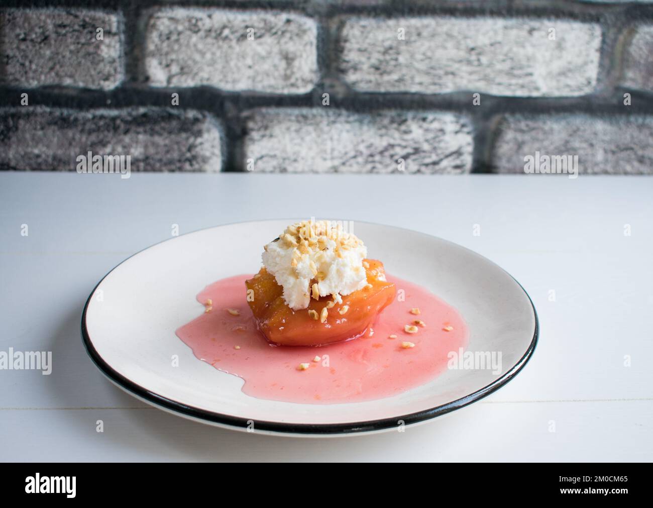 Traditional Turkish quince dessert, quince is cooked in water with sugar and served with cream
