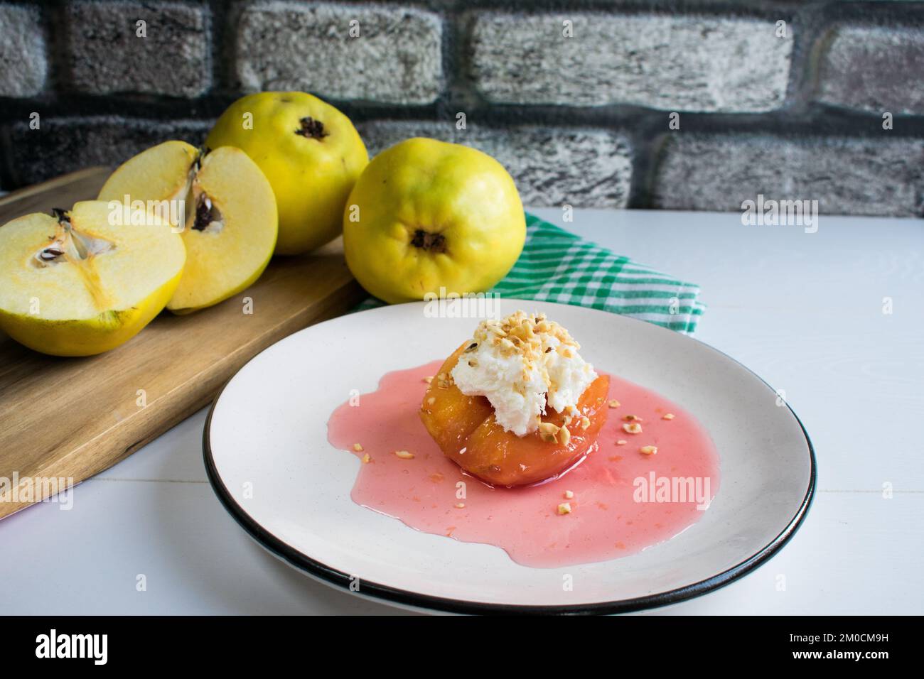 Traditional Turkish quince dessert, quince is cooked in water with sugar and served with cream