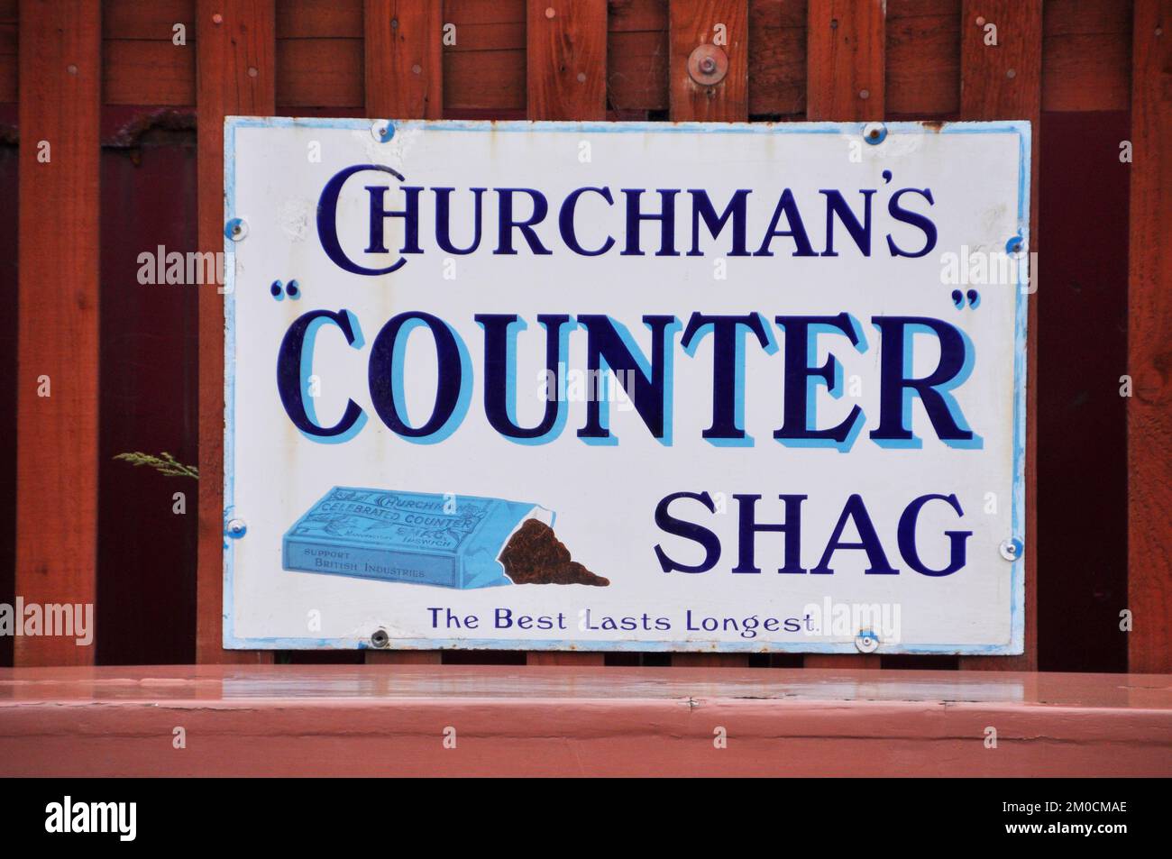Enamelled metal sign, advertising Churchmans pipe tobacco photographed ...