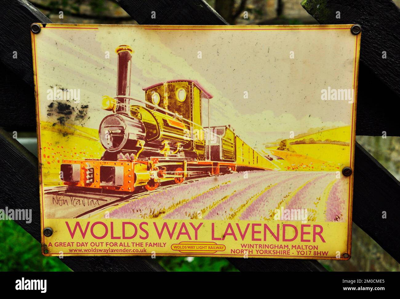 Enamelled metal sign, advertising Woldsway Lavender light railway photographed at Pickering station on the North York Moors railway in Yorkshire,Engla Stock Photo
