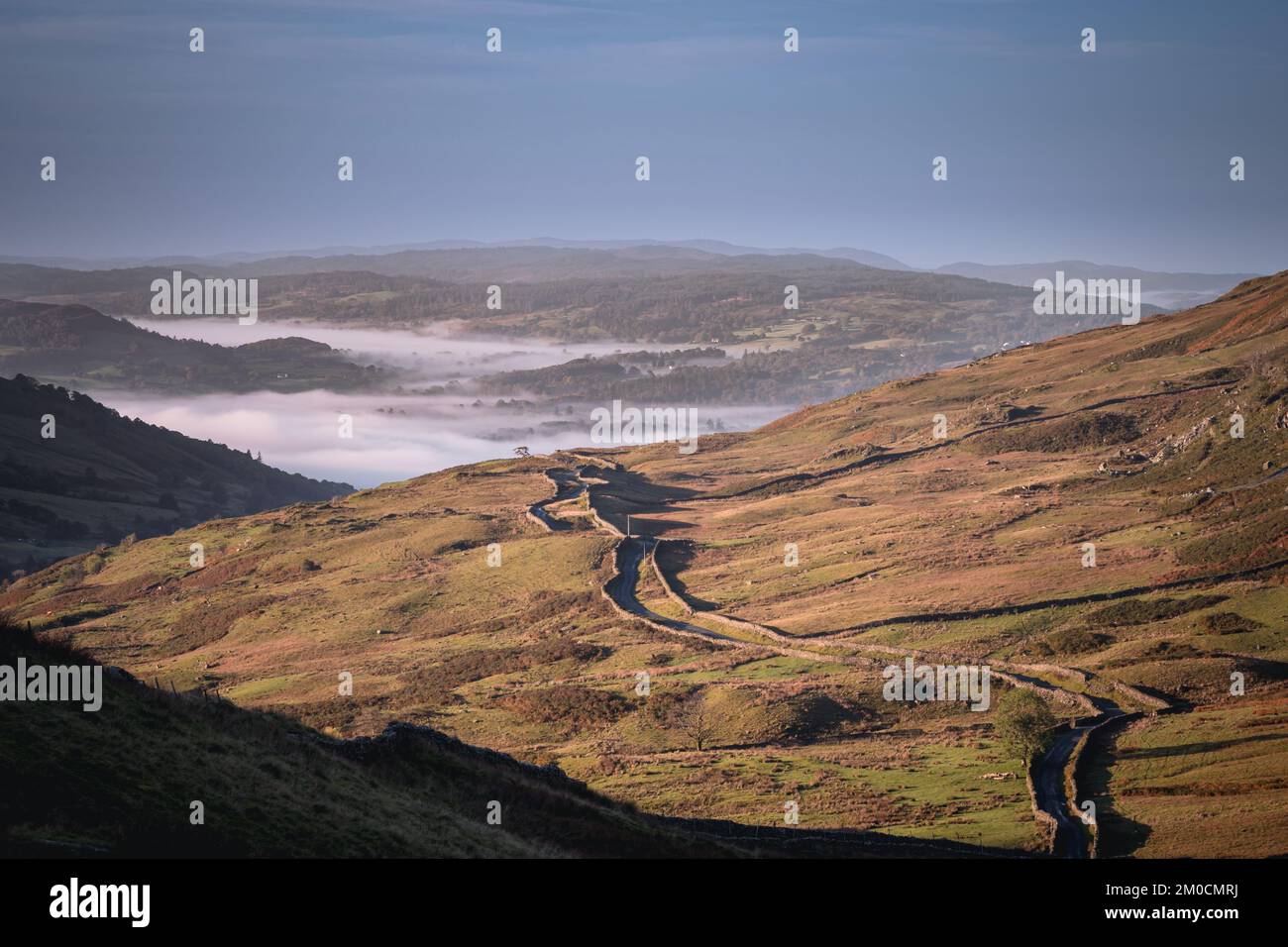 Looking down The Struggle from the Kirkstone Pass with a cloud inversion in the Windermere valley below Stock Photo