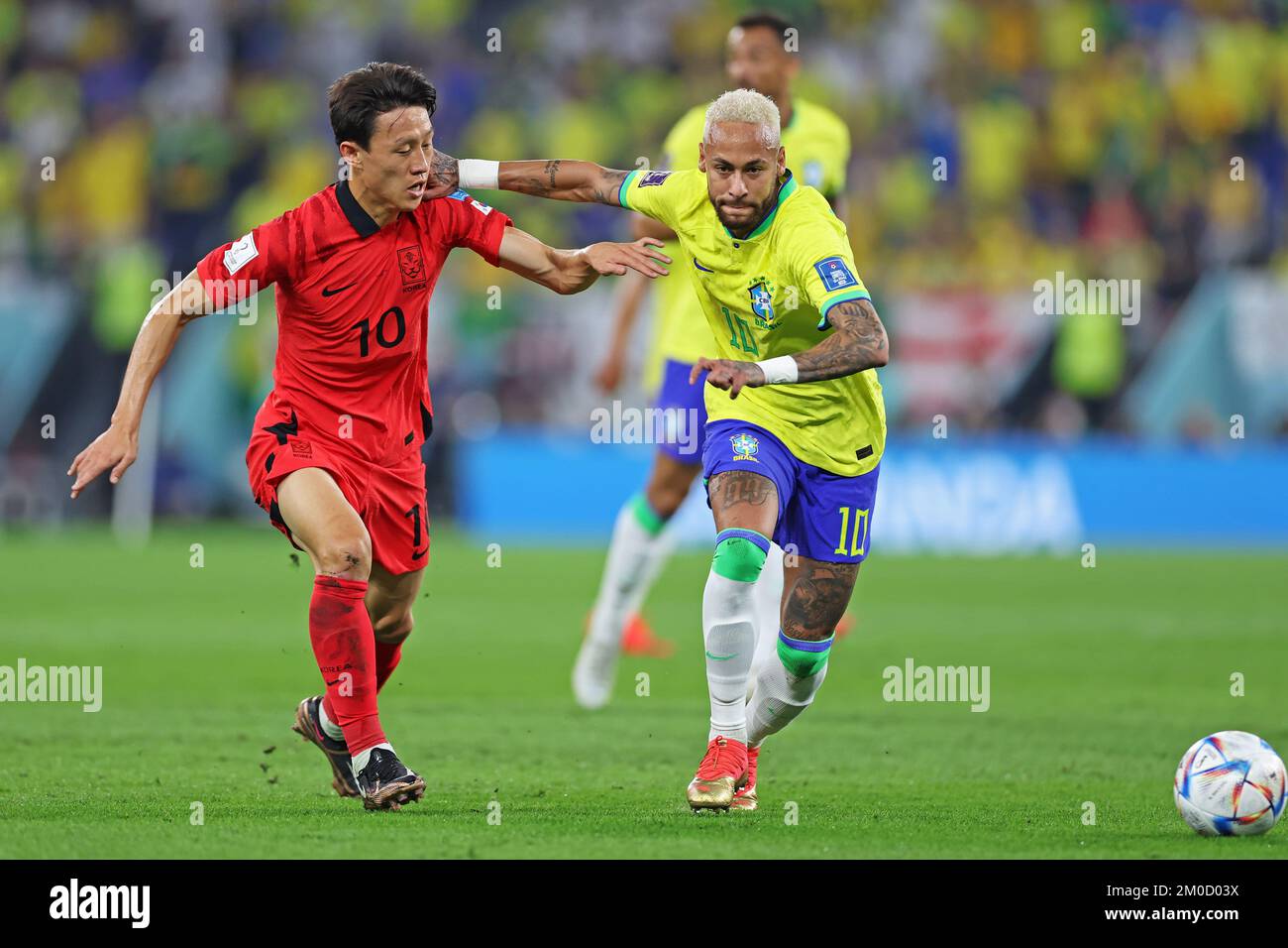 Doha, Qatar: 5th December 2022; FIFA World Cup final 16 round, Brazil versus South Korea: Neymar of Brazil challenges Lee Jae-sung of South Korea for a through ball Stock Photo