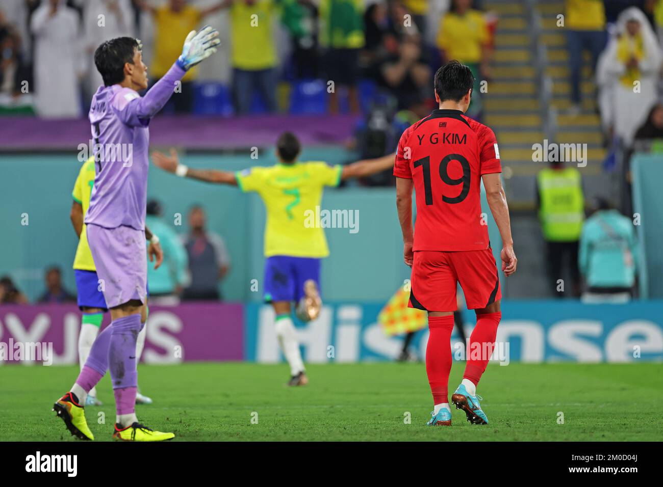 Doha, Qatar: 5th December 2022; FIFA World Cup final 16 round, Brazil versus South Korea: Kim Seung-Gyu and Kim Young-Gwon of South Korea dejected as Lucas Paquetá of Brazil celebrates his goal for 4-0 Stock Photo