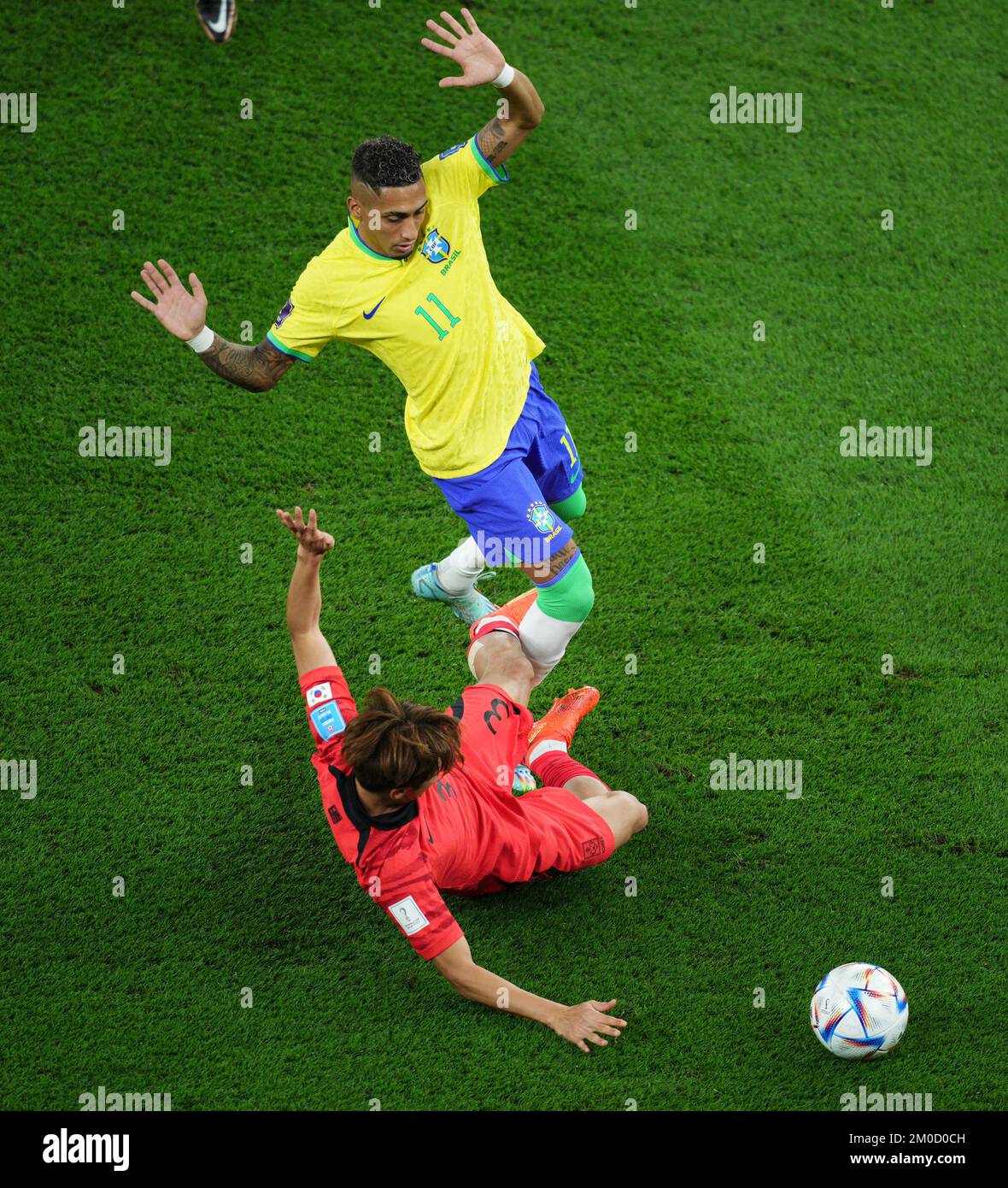 Doha, Qatar. 5th Dec, 2022. Raphinha (Up) of Brazil vies with Kim Jin-su of South Korea during the Round of 16 match between Brazil and South Korea at the 2022 FIFA World Cup at Stadium 974 in Doha, Qatar, Dec. 5, 2022. Credit: Xin Yuewei/Xinhua/Alamy Live News Stock Photo
