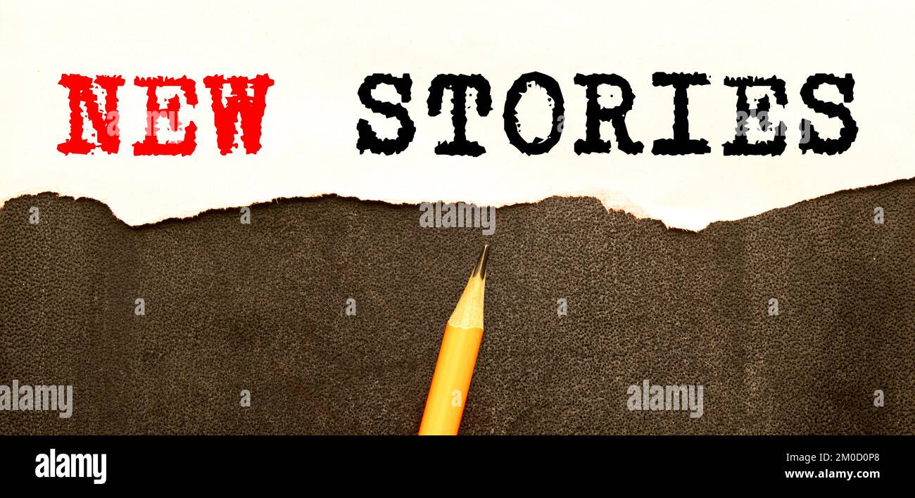 NEW STORIES - note concept text the table Stock Photo - Alamy