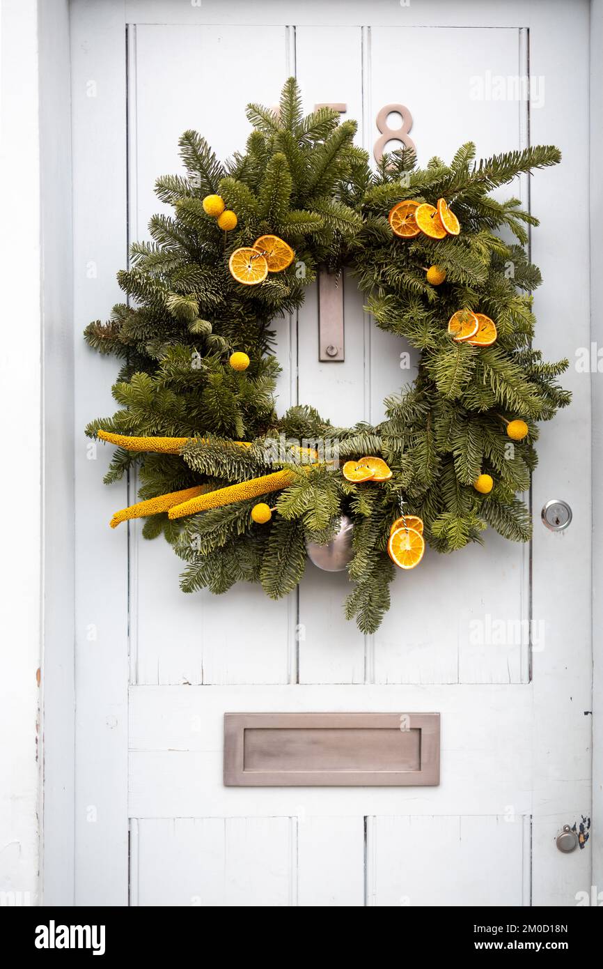 Christmas wreath of fir branches with Hypericum berries decorates the ...