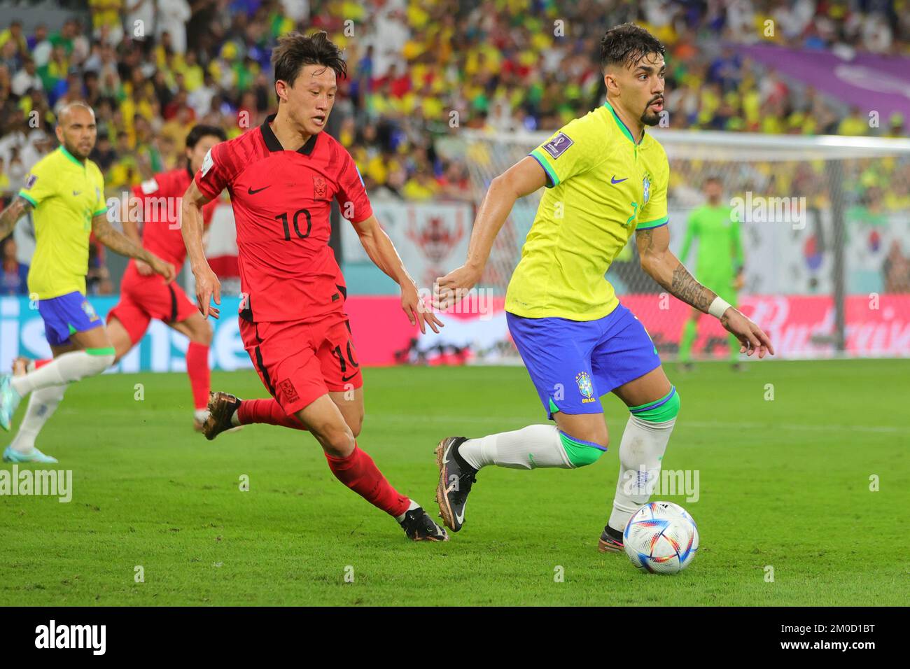 Qatar, 05/12/2022, Doha, Qatar. 05th Dec, 2022. Lucas Paqueta of Brazil dribbles the ball with Jaesung Lee of Korea Republic in pursuit during the FIFA World Cup Qatar 2022 match between Brazil and South Korea at Stadium 974, Doha, Qatar on 5 December 2022. Photo by Peter Dovgan. Editorial use only, license required for commercial use. No use in betting, games or a single club/league/player publications. Credit: UK Sports Pics Ltd/Alamy Live News Stock Photo