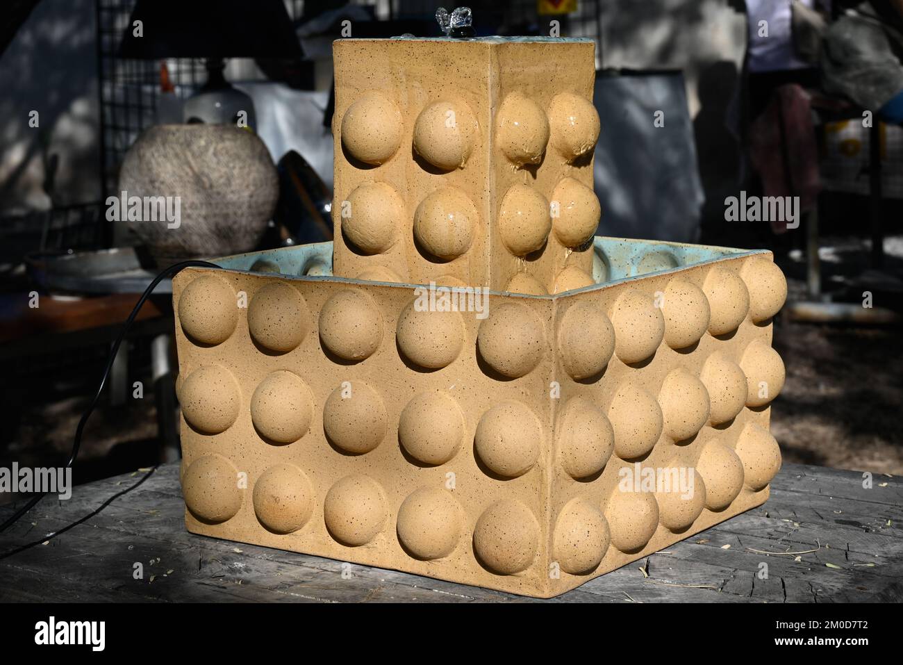 Wonderfully brutalist water feature made of ceramic and powered by solar displayed at art fair in Tucson, AZ Stock Photo
