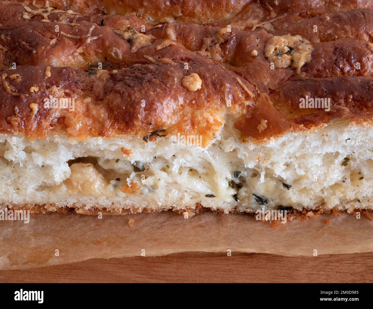 Freshly baked buttery, garlic-flecked bread, close up. Soft crumb of parmesan garlic bread Stock Photo