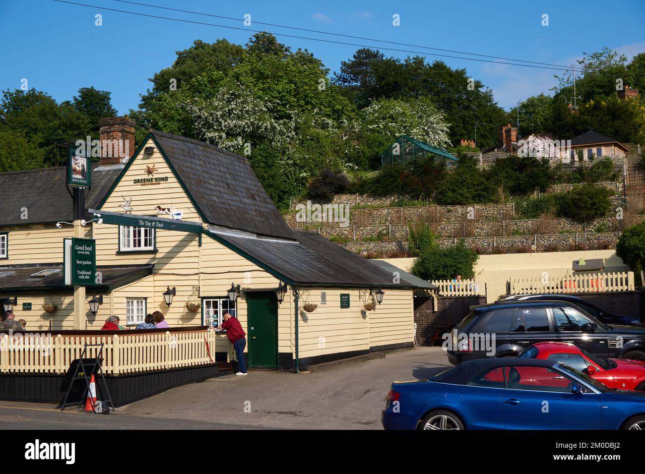Traditional British pub and car park with unusual stepped wall to the
