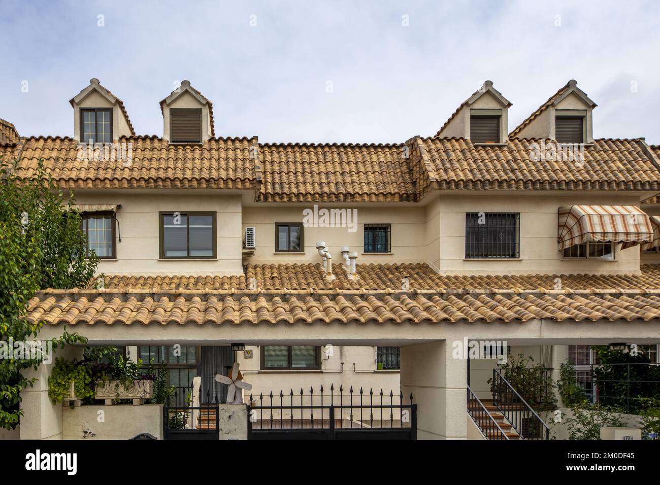 Urbanization with twostory houses with patios and common areas with mud roofs, attics with