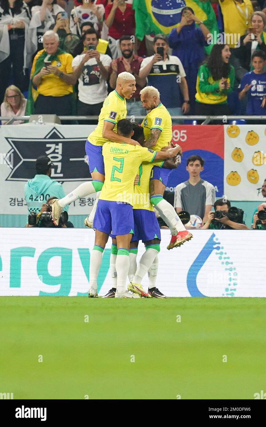DOHA, QATAR - DECEMBER 5: Player of Brazil Vinícius Júnior celebrates with this teammates Lucas Paquetá, Danilo, Richarlison and Neymar after scoring a goal fights for the ball with player of South Korea during the FIFA World Cup Qatar 2022 Round of 16 match between Brazil and South Korea at Stadium 974 on December 5, 2022 in Doha, Qatar. (Photo by Florencia Tan Jun/PxImages) Stock Photo