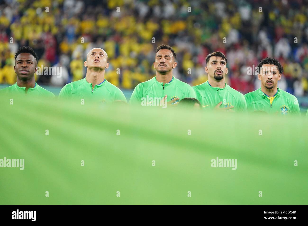DOHA, QATAR - DECEMBER 5: Players of Brazil Vinícius Júnior, Richarlison, Danilo, Lucas Paquetá and Marquinhos sing the national anthem before the FIFA World Cup Qatar 2022 Round of 16 match between Brazil and South Korea at Stadium 974 on December 5, 2022 in Doha, Qatar. (Photo by Florencia Tan Jun/PxImages) Stock Photo