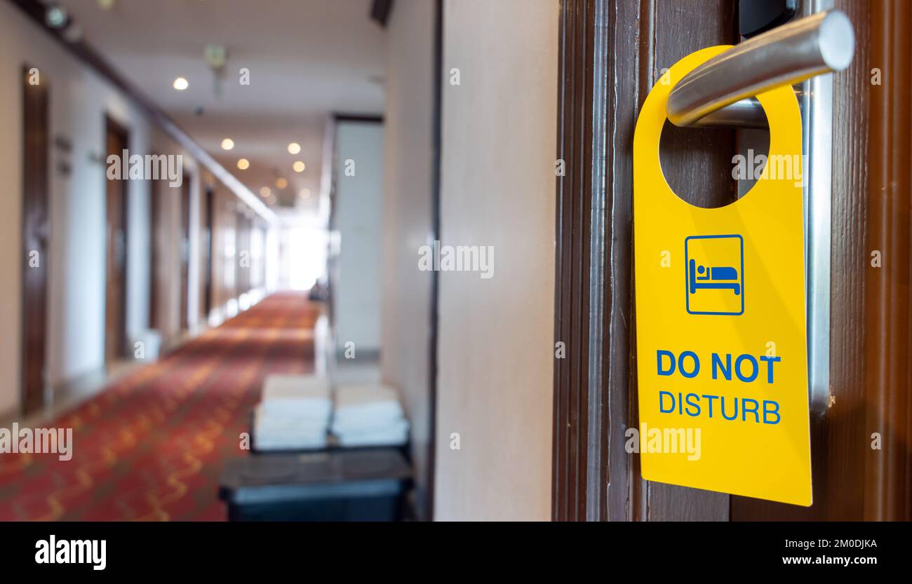 The sign Do Not Disturb hangs on the doorknob of the hotel room Stock