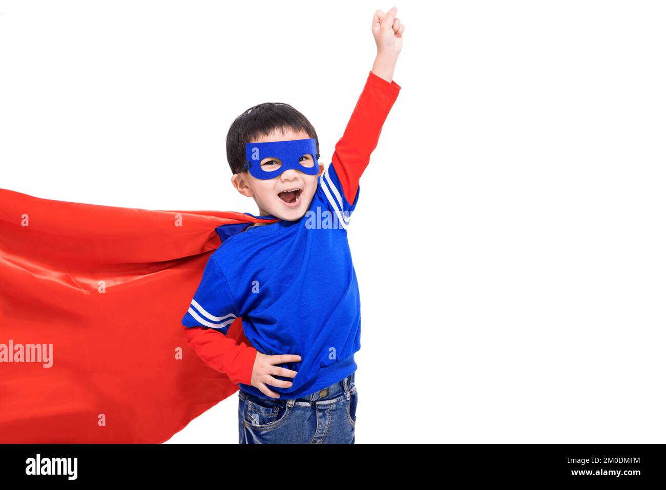 Excited kid in red  hero cape and mask Stock Photo