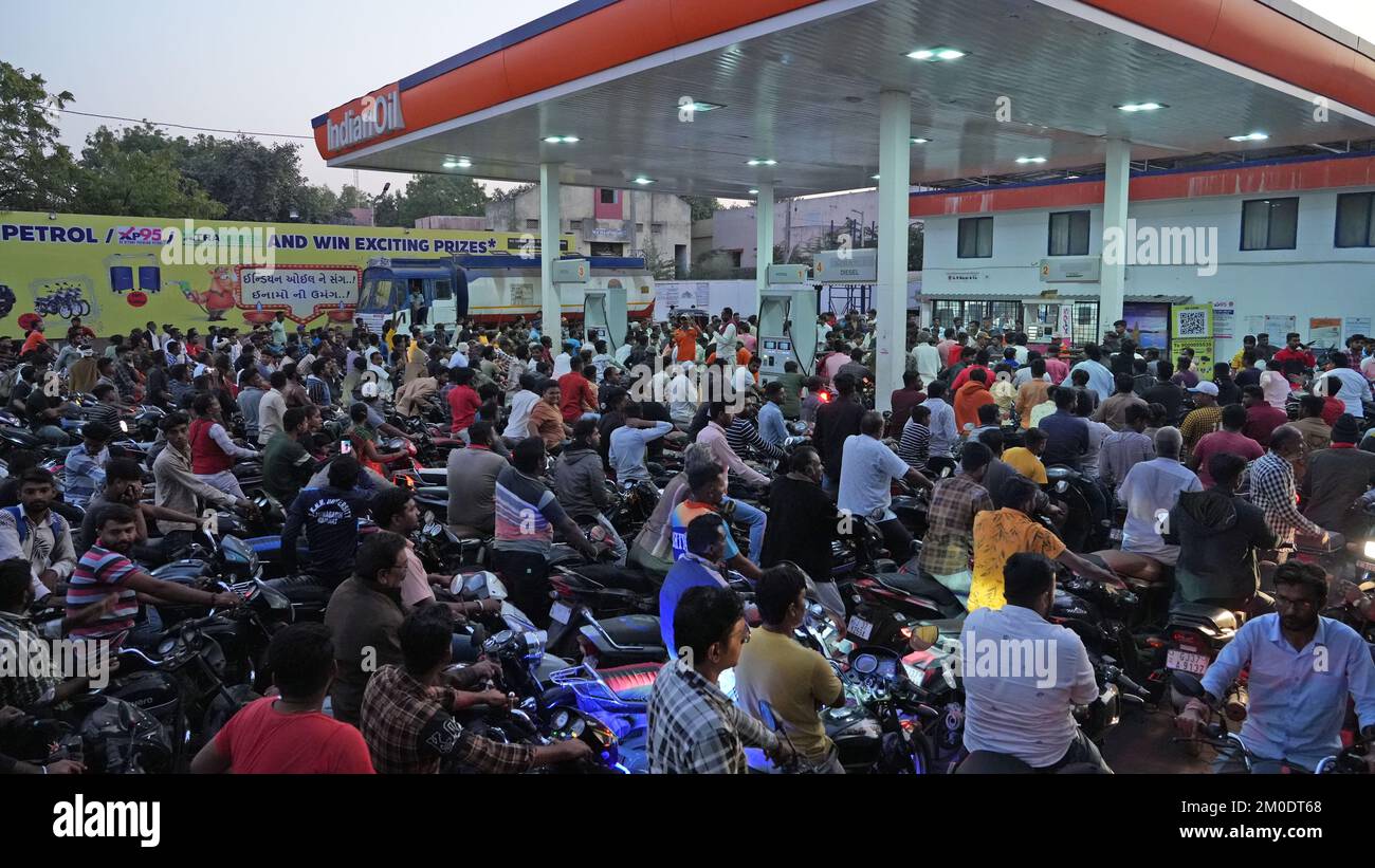 Dwarka, Gujarat, India. 30th Nov, 2021. Commuters wait to fuel their