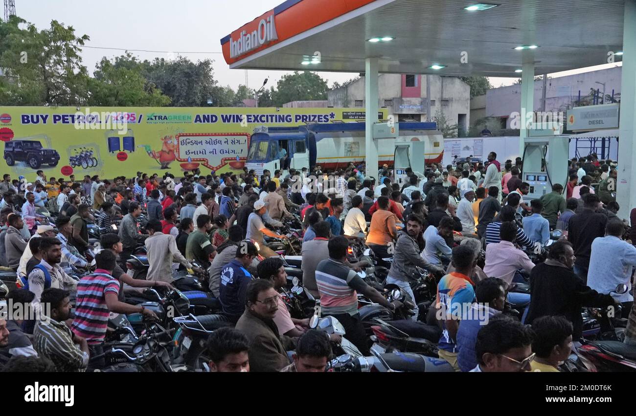 Dwarka, Gujarat, India. 30th Nov, 2021. Commuters wait to fuel their