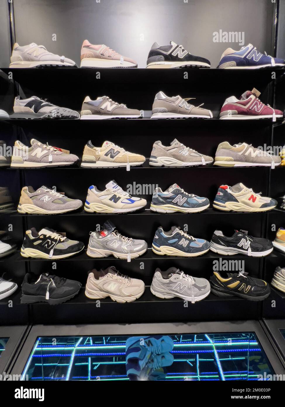 Cool shelves display of New Balance sneakers for customer's selection Stock Photo