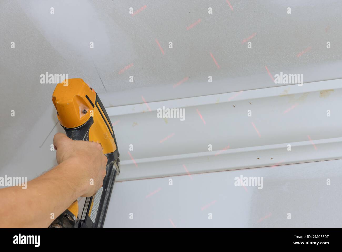 Ceiling corner crown molding installation with the use of an air nail