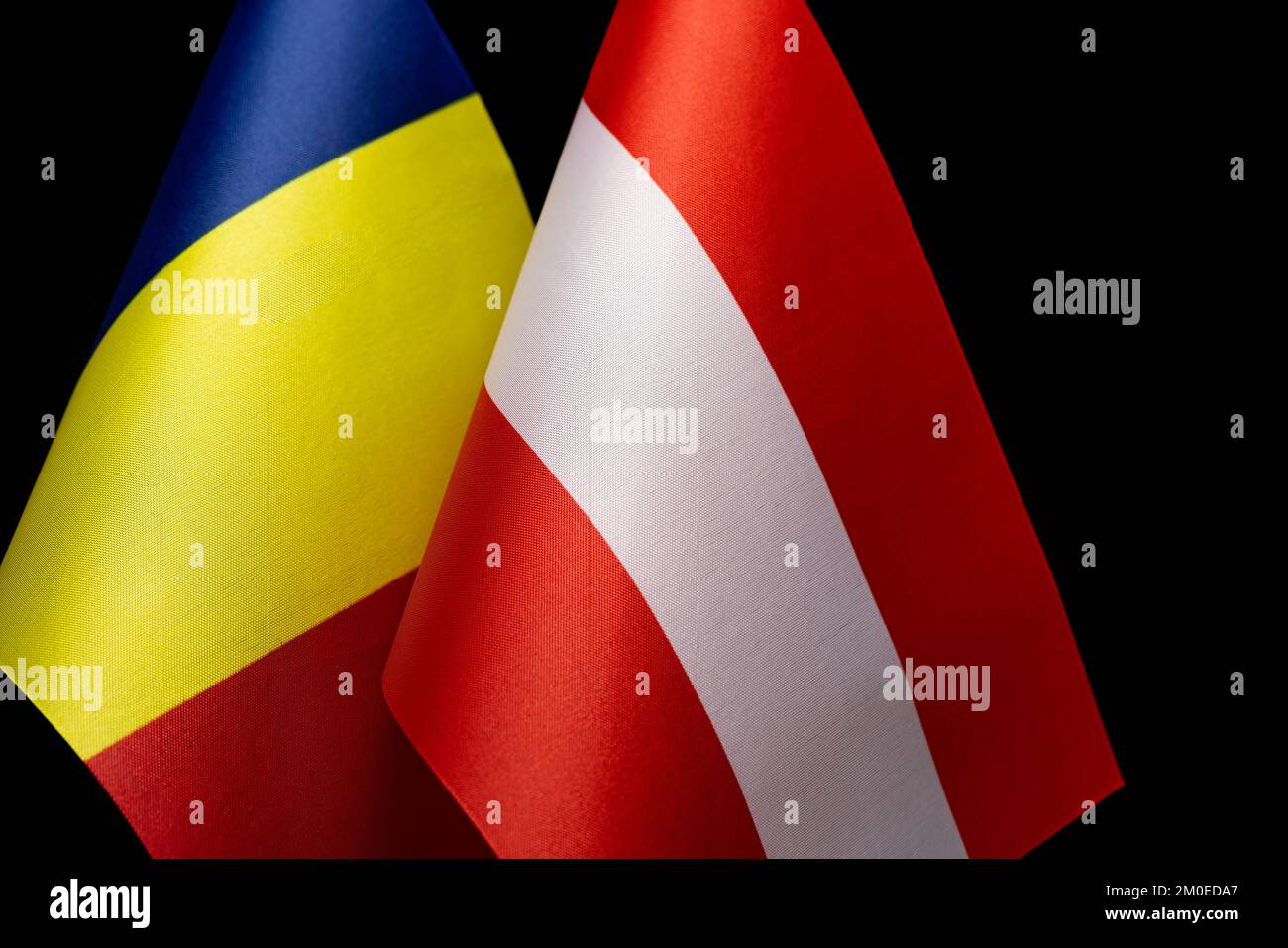 Flags of Romania and Austria, concept of countries relations and conflicts Stock Photo