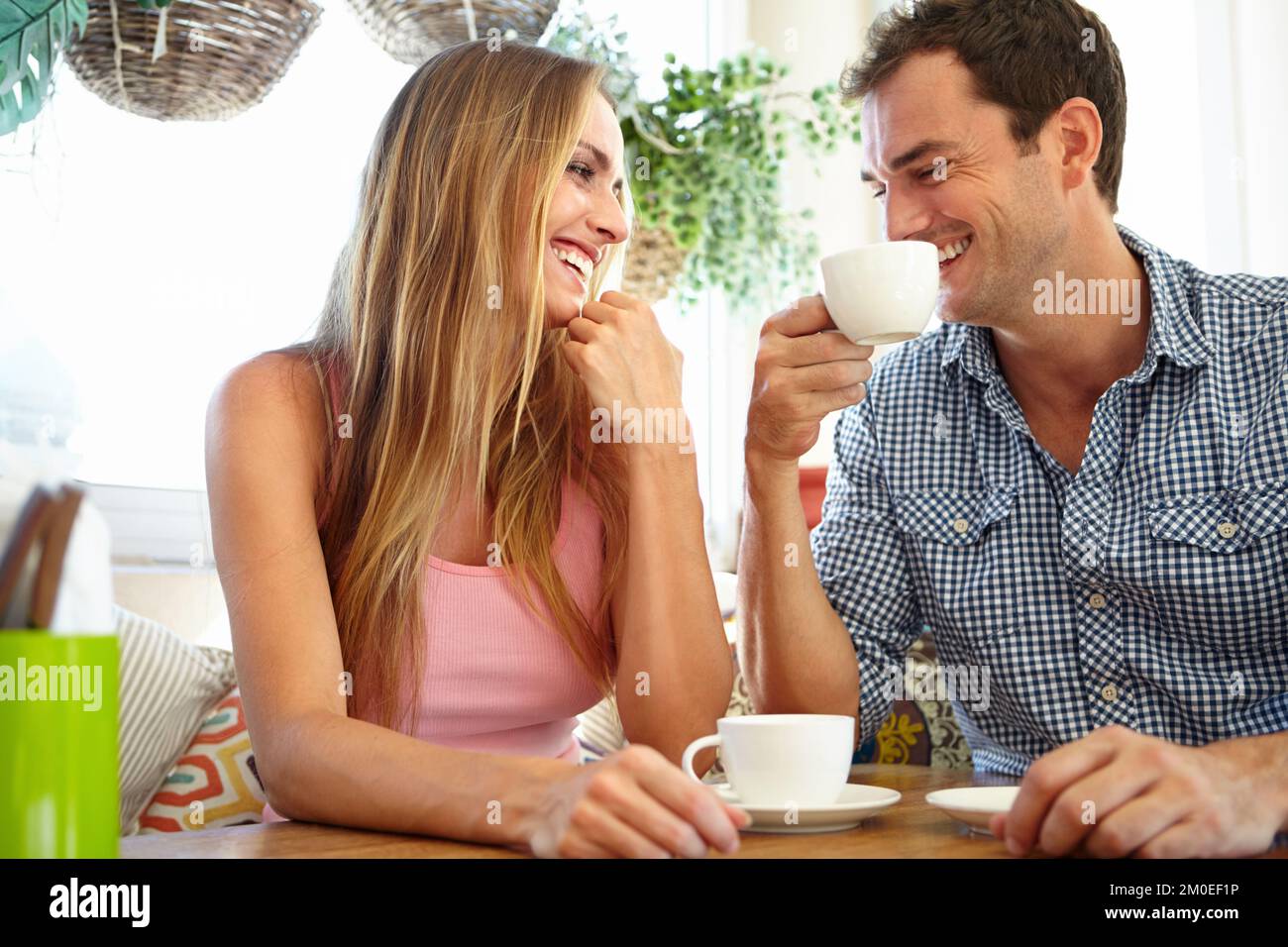Coffee shop conversation. An attractive young couple enjoying a cup of coffee in restaurant. Stock Photo